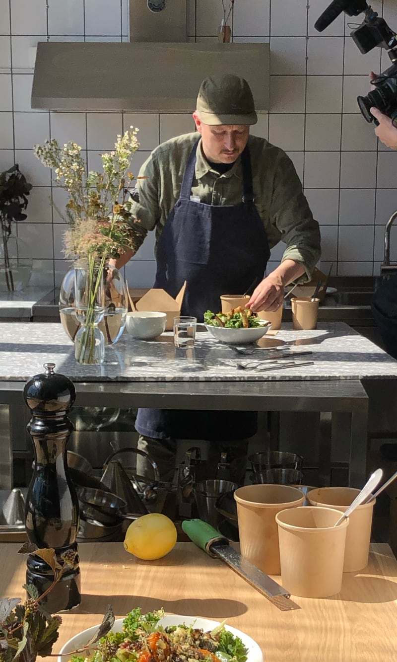 A chef plating during a shoot