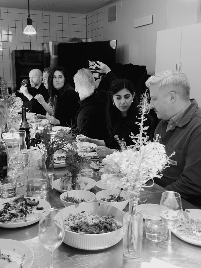 People sitting at a table eating and talking.